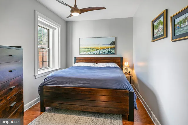 a bed sitting in a bedroom next to a window