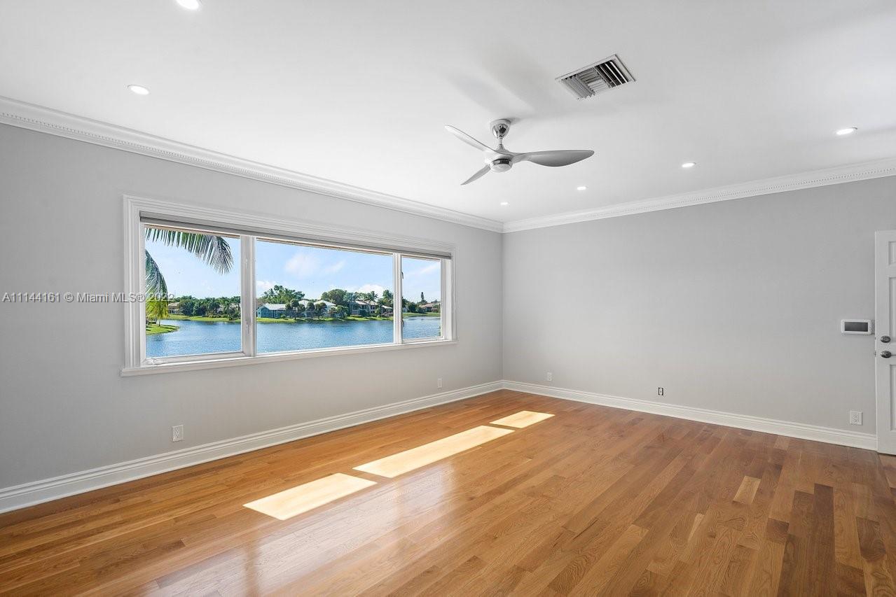 3060 Hampton Place Boca Raton, FL 33434 - Photo 30 of 60 a view of empty room with wooden floor and fan