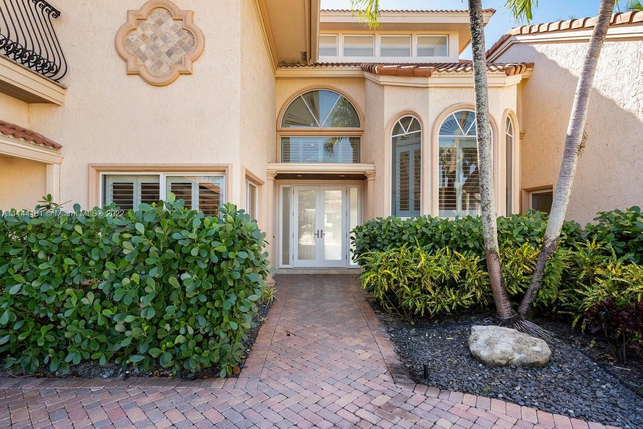 3060 Hampton Place Boca Raton, FL 33434 - Photo 4 of 60 a view of a brick house with potted plants