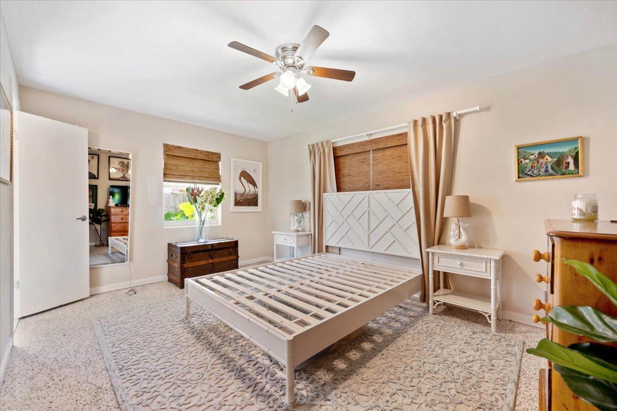 200 East 28th Street Riviera Beach, FL 33404 - Photo 13 of 22 a bedroom with a bed a computer on desk and a dresser