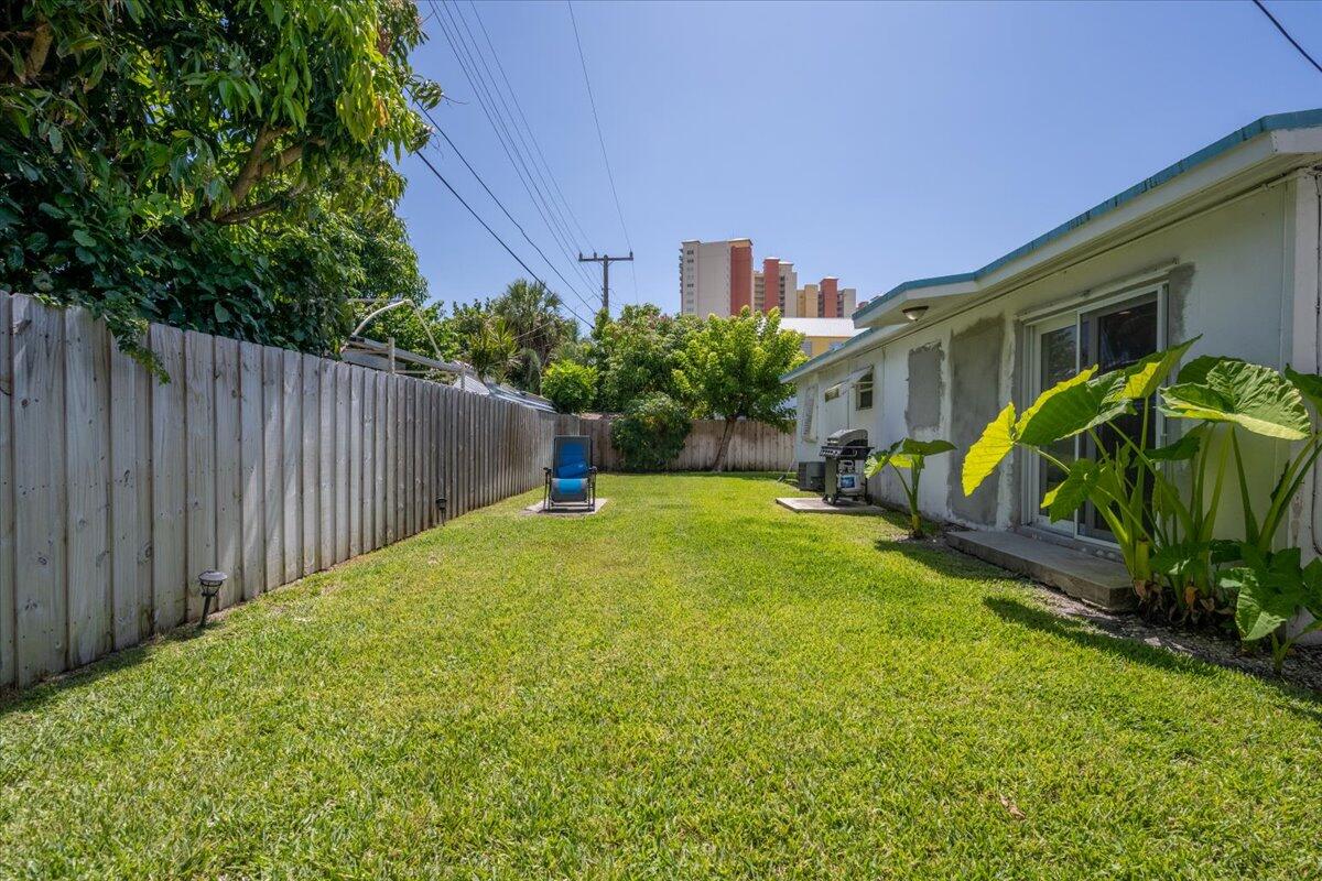 200 East 28th Street Riviera Beach, FL 33404 - Photo 15 of 22 a view of a backyard with plants and a patio