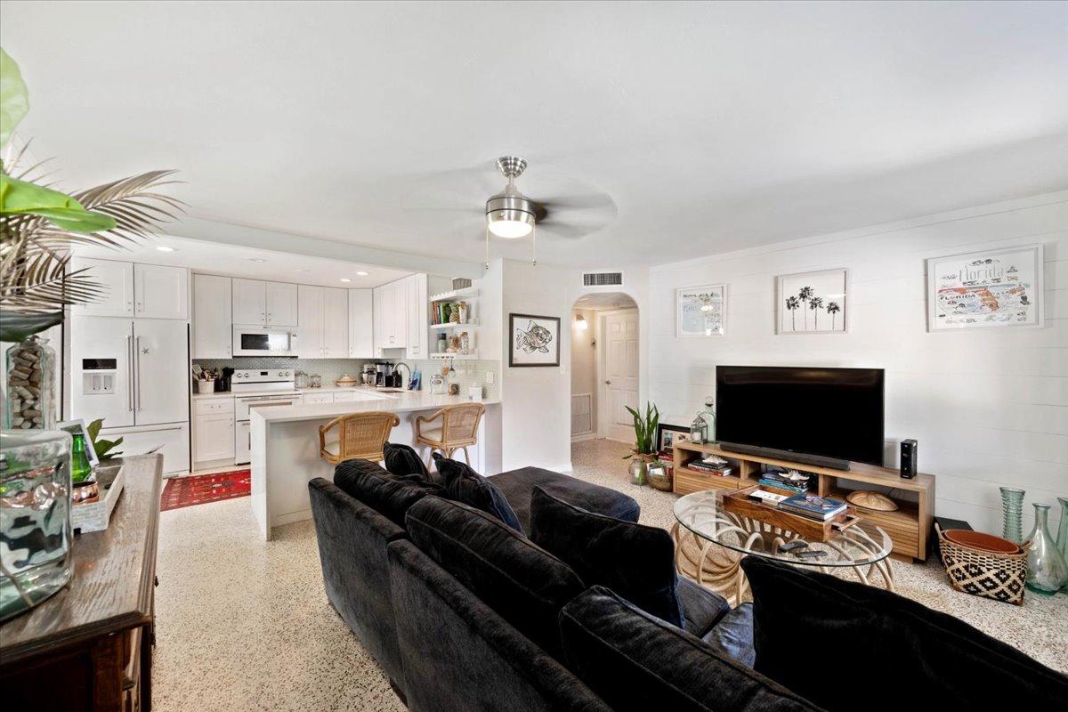 200 East 28th Street Riviera Beach, FL 33404 - Photo 5 of 22 a living room with furniture and a flat screen tv