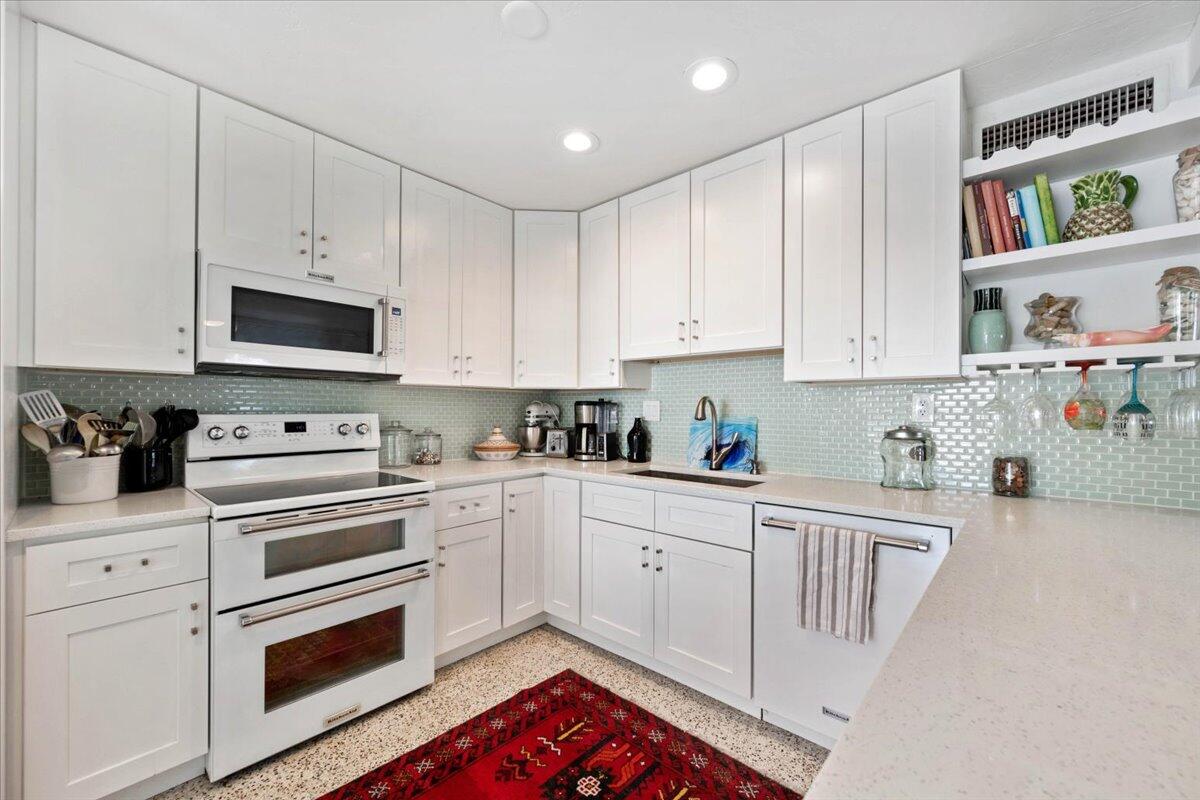 200 East 28th Street Riviera Beach, FL 33404 - Photo 8 of 22 a kitchen with cabinets appliances and a sink