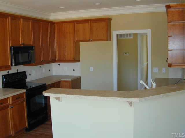 3901 Willow Oak Road Raleigh, NC 27604 - Photo 2 of 4 a kitchen with a sink a stove and a microwave