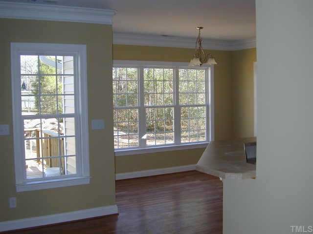 3901 Willow Oak Road Raleigh, NC 27604 - Photo 4 of 4 a view of an empty room with wooden floor and a window