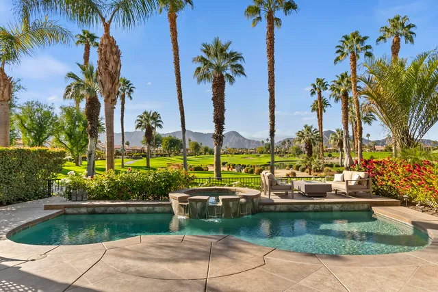 a view of a swimming pool with a table and chairs