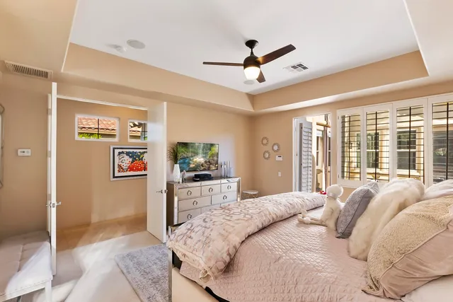 a bedroom with a balcony a bed and a flat screen tv