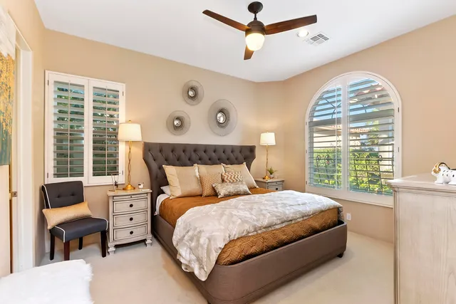 a bedroom with a large bed and a large window