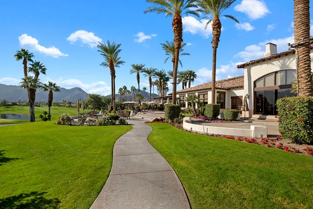 a front view of a building with dining garden and plants