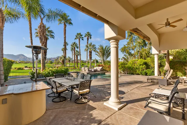 a view of a patio with a dining table and chairs