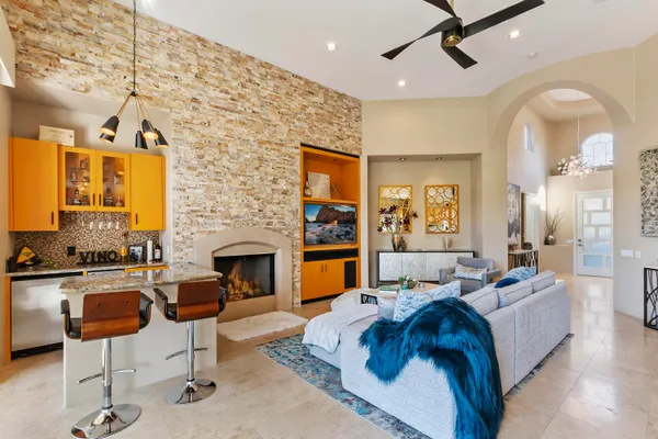 a living room with furniture fireplace and window