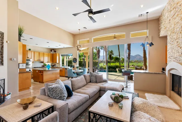 a living room with furniture wooden floor and a large window
