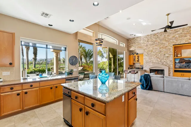 a kitchen with sink cabinets and living room view