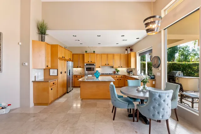 a large kitchen with a table and chairs