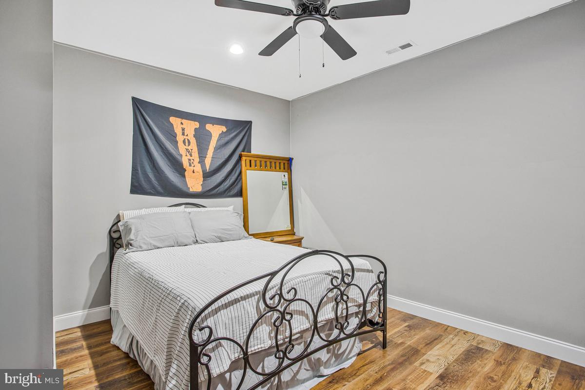 5 Jessie Road Harwood, MD 20776 - Photo 56 of 87 a bedroom with a bed and a painting on the wall