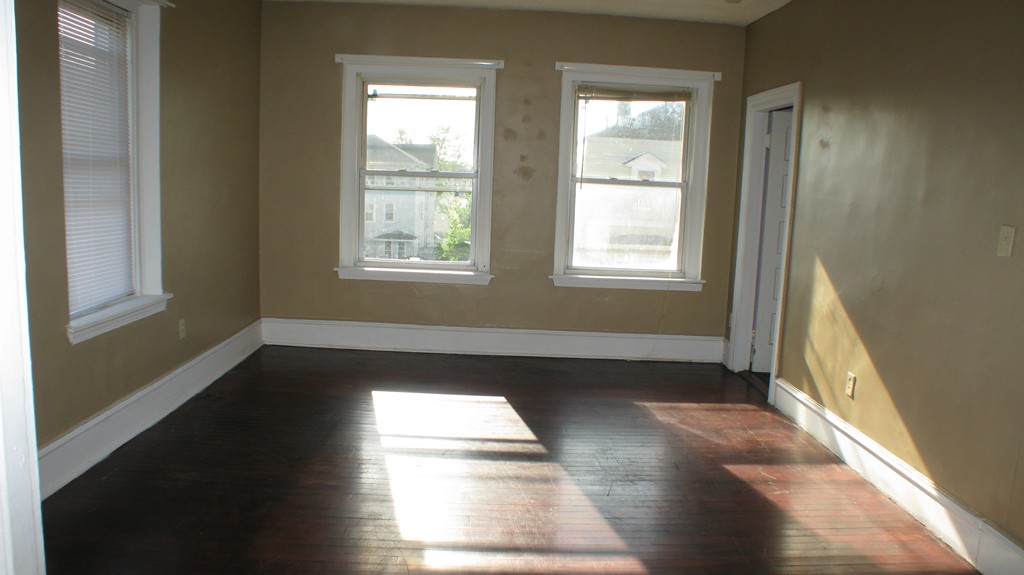 344 East Main Street Fall River, MA 02724 - Photo 3 of 6 a view of an empty room with wooden floor and a window