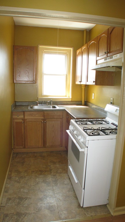 344 East Main Street Fall River, MA 02724 - Photo 5 of 6 a kitchen with a stove and a sink