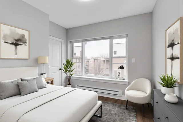 a bedroom with a bed and a potted plant