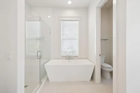 a bathroom with a sink vanity mirror and toilet