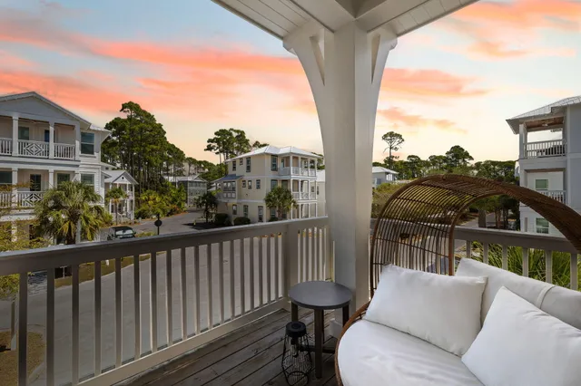 a living room with furniture kitchen view and a large window