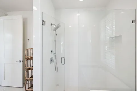 a view of a white house with a street