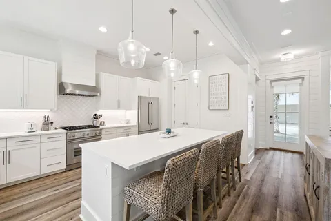 a kitchen with sink stove and cabinets