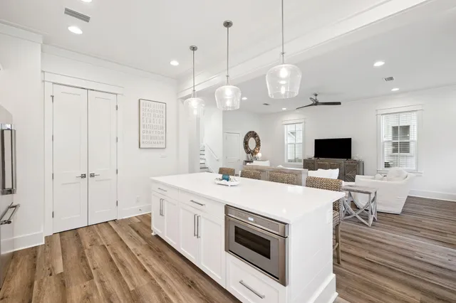 a kitchen with a sink a stove a refrigerator and a fireplace