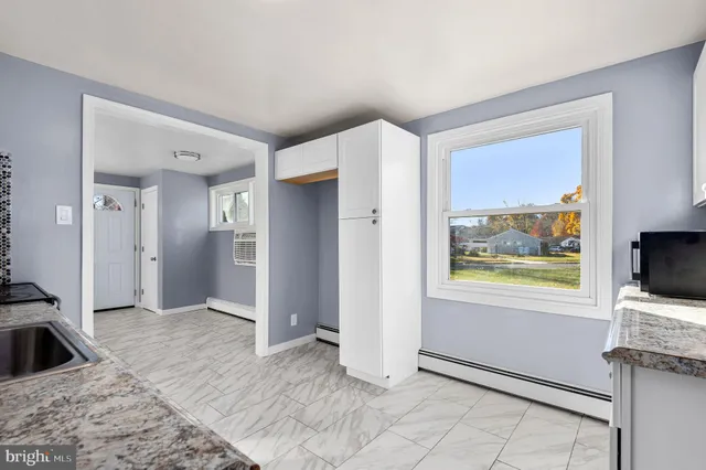 a view of a livingroom with wooden floor and a flat screen tv