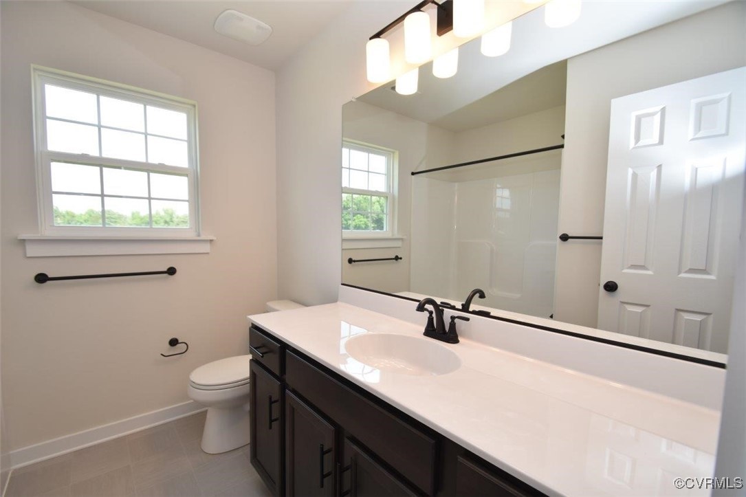 8729 Carters Mill Road Henrico, VA 23231 - Photo 18 of 33 Bathroom featuring vanity, toilet, and walk in sho