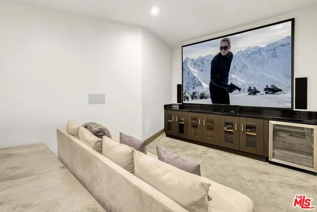 a living room with furniture and painting on the wall