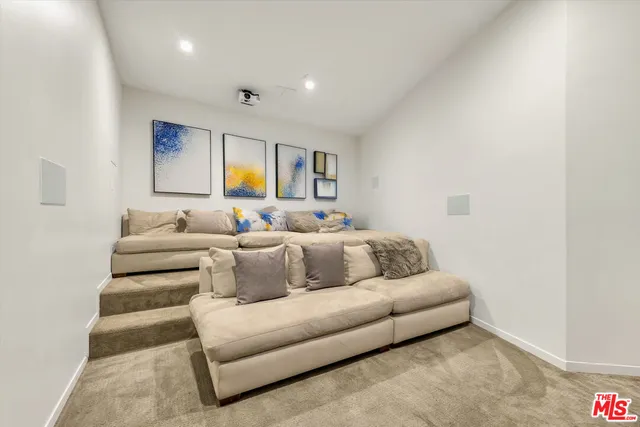 a living room with furniture and a air conditioner vent