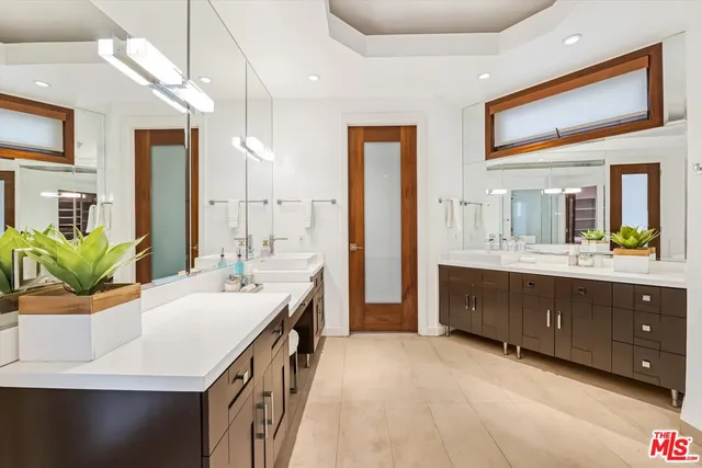a bathroom with a sink double vanity and a mirror