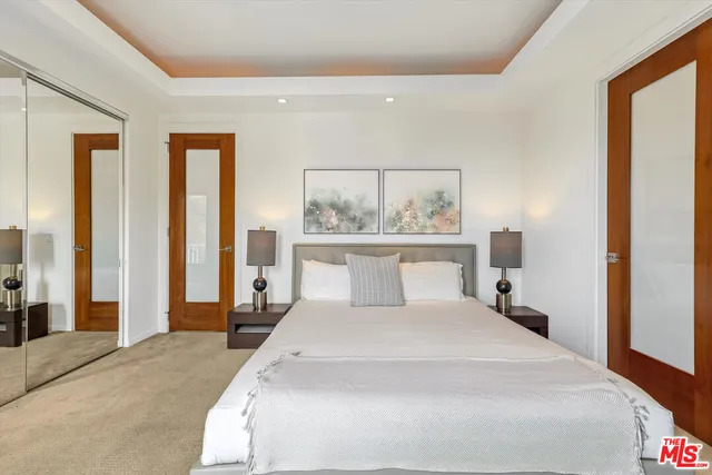 a bathroom with a granite countertop sink a toilet a shower and a mirror