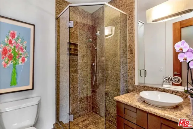 a bedroom with a balcony a bed and a large window