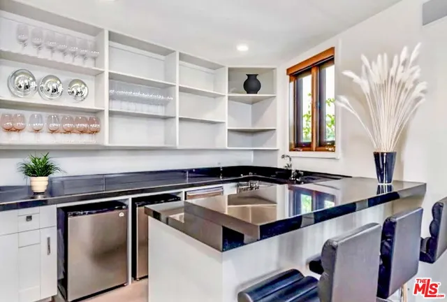 a kitchen with stainless steel appliances granite countertop a sink a stove and a refrigerator