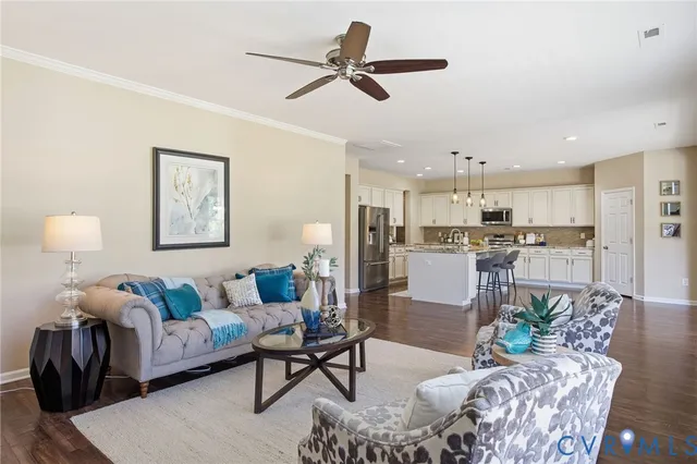 a living room with furniture and a view of kitchen
