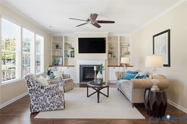a living room with furniture a fireplace and a flat screen tv