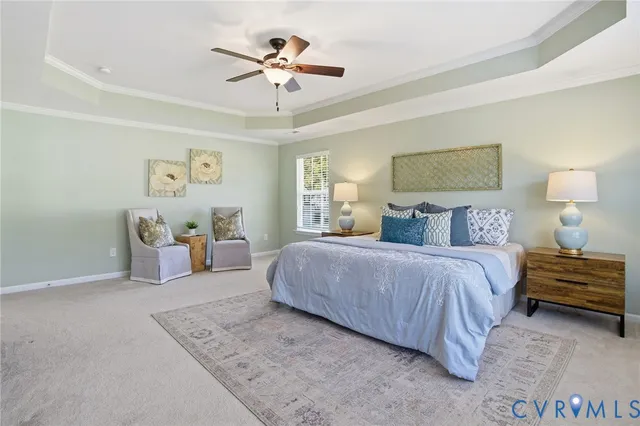 a spacious bedroom with a bed and a chandelier