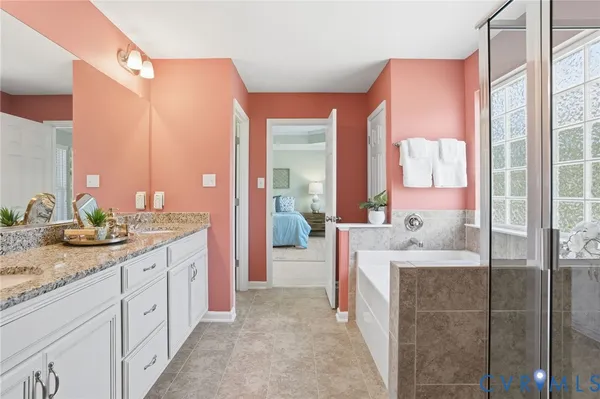 a spacious bathroom with a granite countertop sink and a mirror