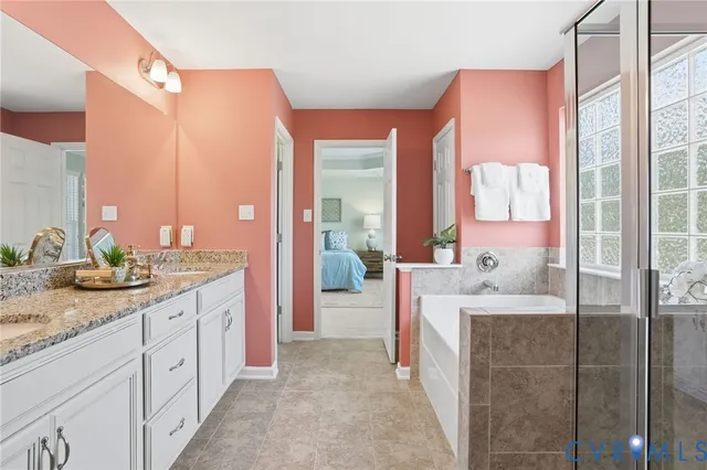 a spacious bathroom with a granite countertop sink and a mirror