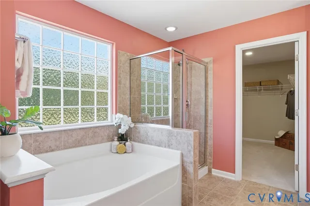 a bath tub sitting in a bathroom next to a window