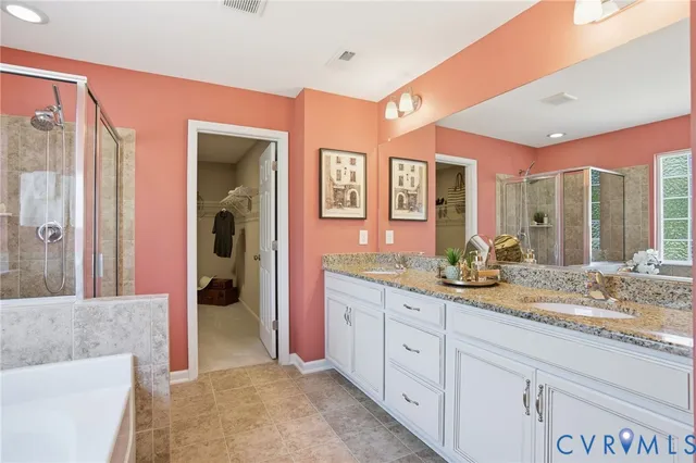 a spacious bathroom with a granite countertop sink mirror and shower