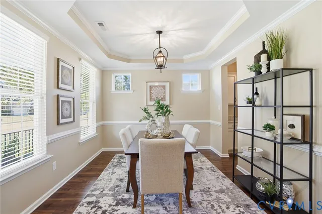 a dining room with furniture window and wooden floor