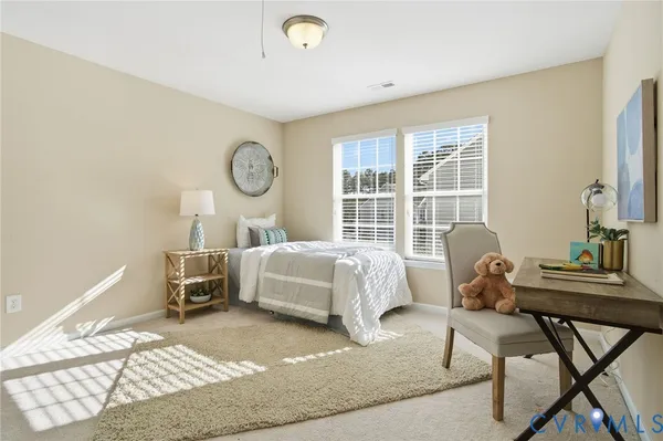 a bedroom with a bed chair and a window