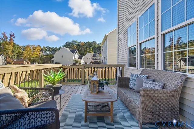 a balcony with furniture and wooden floor