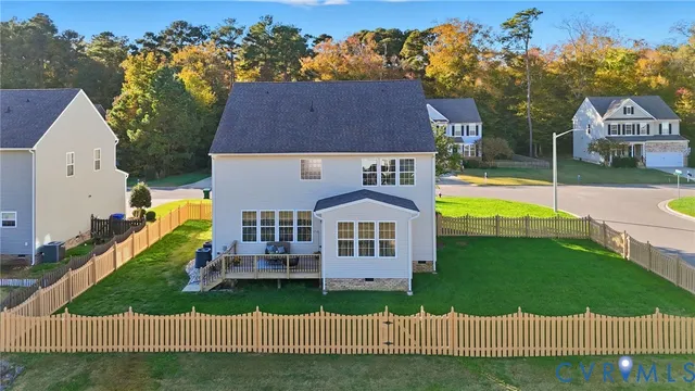 an aerial view of a house with a garden and swimming pool