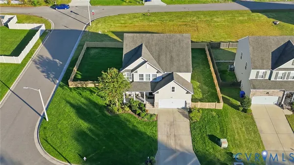 an aerial view of a house with a garden and swimming pool