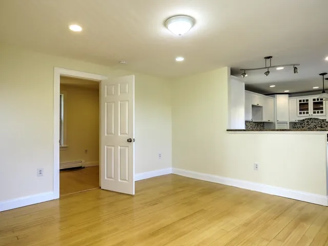 an empty room with a kitchen and a sink