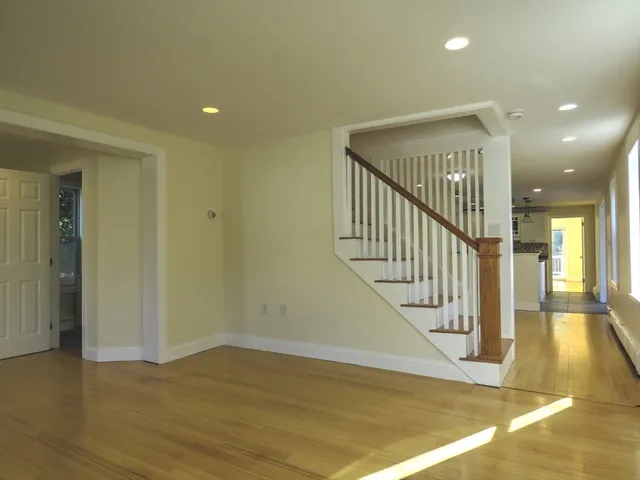 a view of entryway and hall with wooden floor