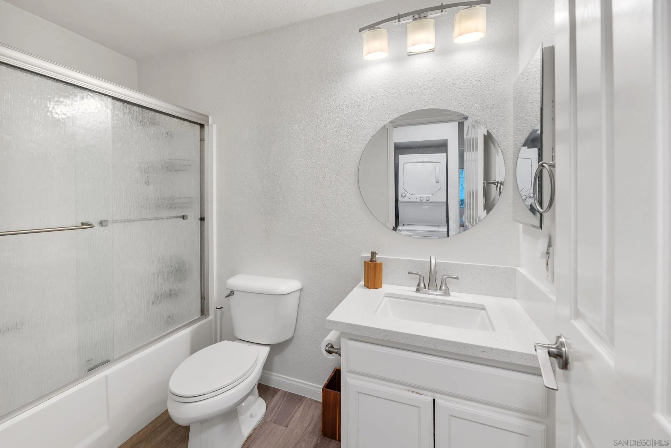 1810 South El Camino Real, Unit 101 Encinitas, CA 92024 - Photo 17 of 39 a bathroom with a toilet sink and mirror